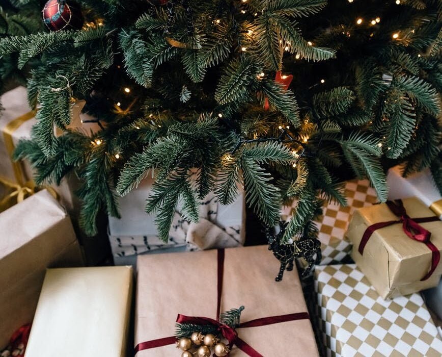 christmas gift boxes under fir tree