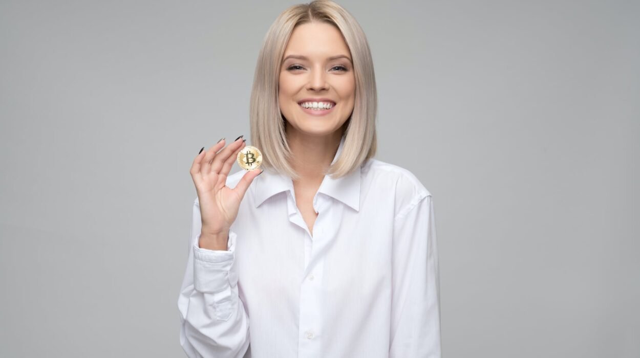 women wearing white long sleeved collared shirt holding bitcoin